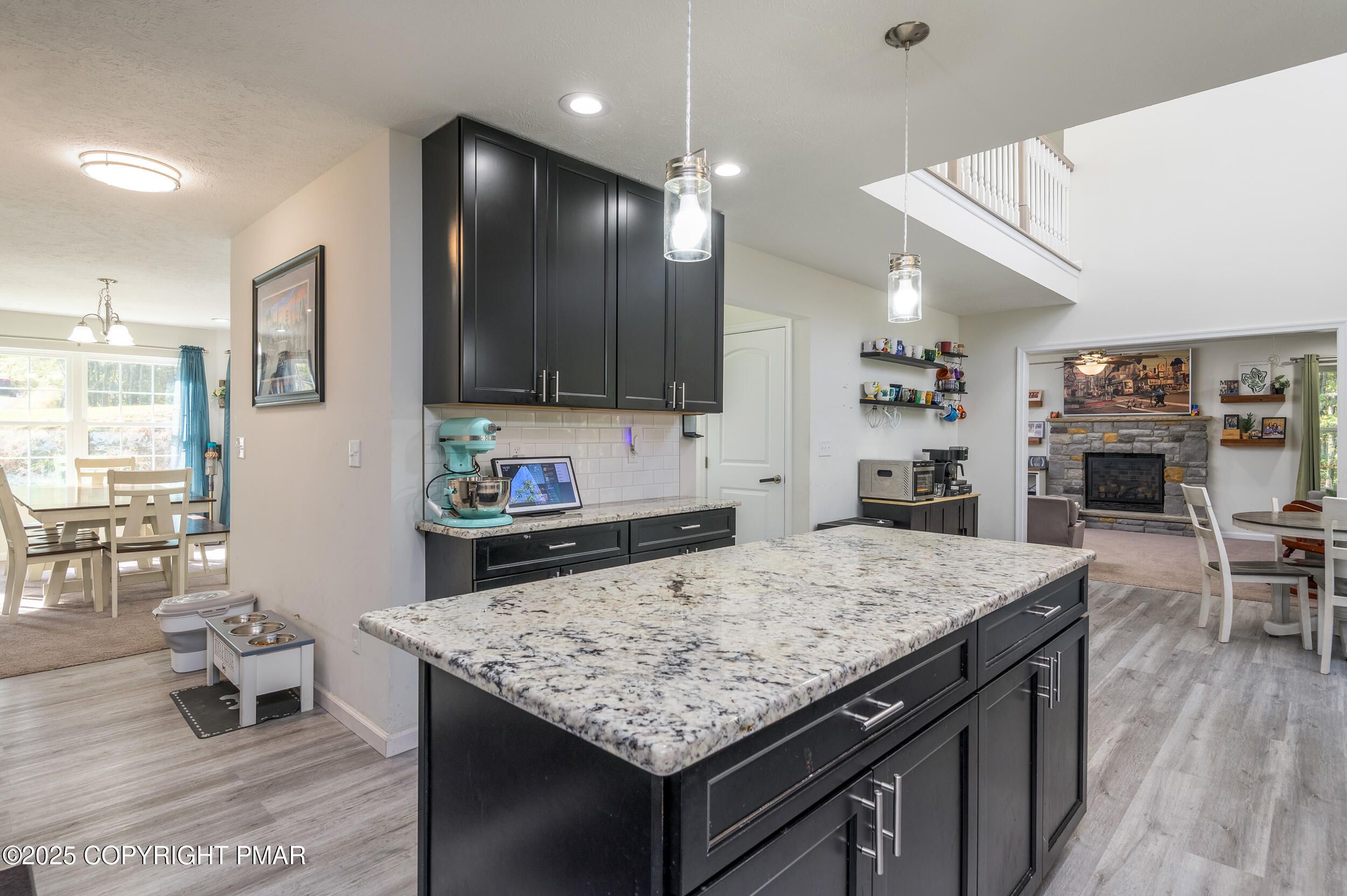 322 Russell Court Effort, PA 18330 - Photo 22 of 45 a kitchen with granite countertop kitchen island stainless steel appliances a sink stove and living room view