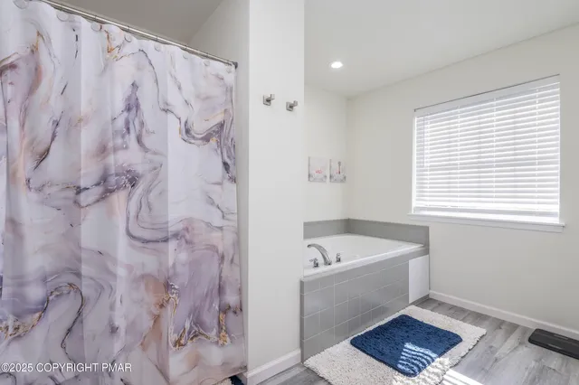 a bathroom with a bathtub and a shower