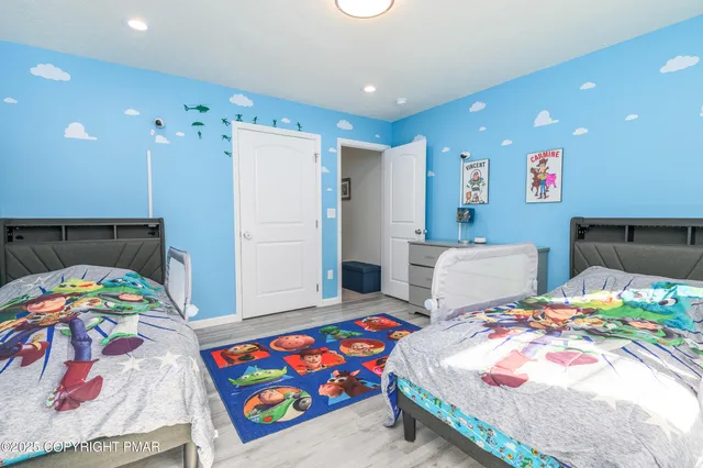 a bedroom with bed and a two dresser