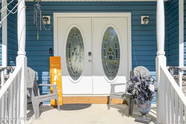 a front view of a house with garden and plants