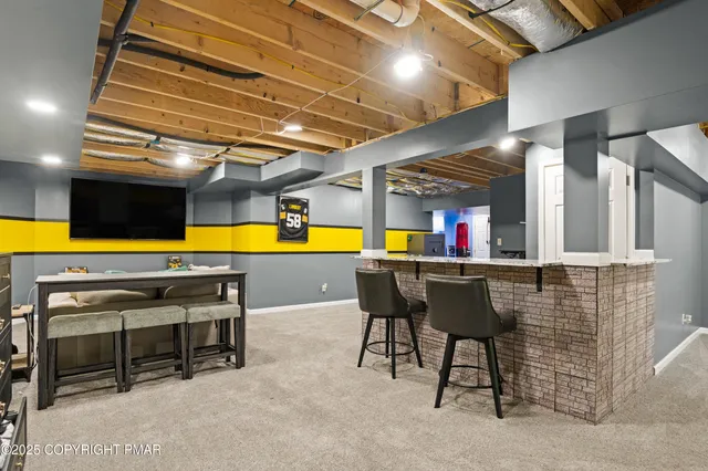a view of a room with chairs and pool table