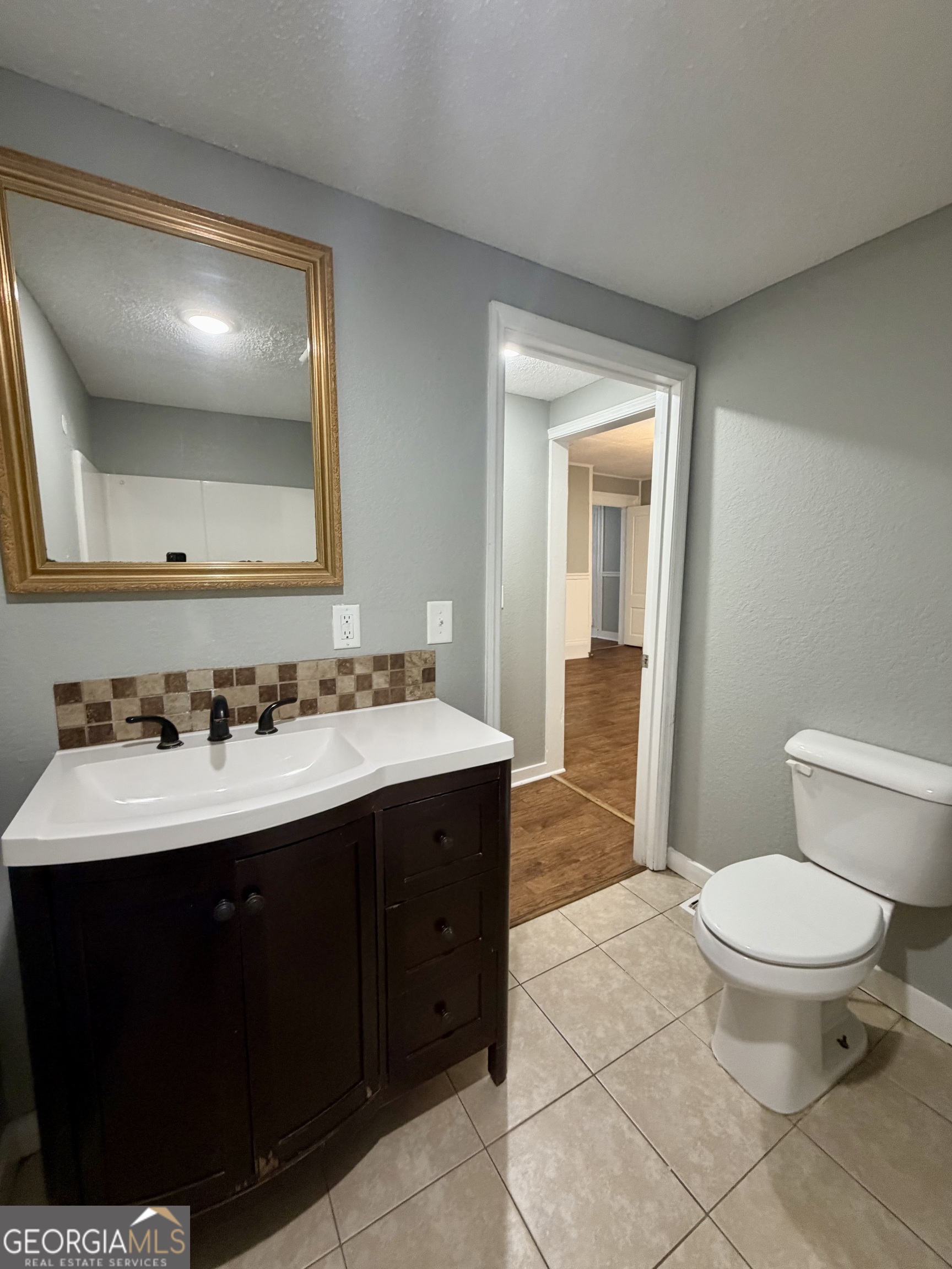 666 Woolfolk Street Macon, GA 31217 - Photo 26 of 60 a bathroom with a sink and a mirror