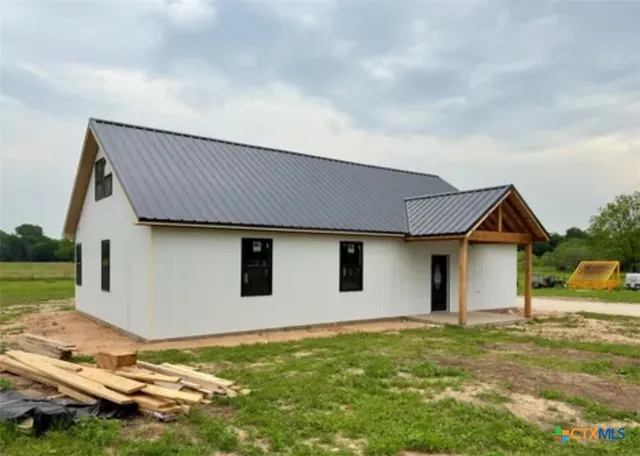 a backyard of a house with wooden fence