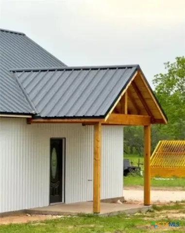 a backyard of a house with table and chairs