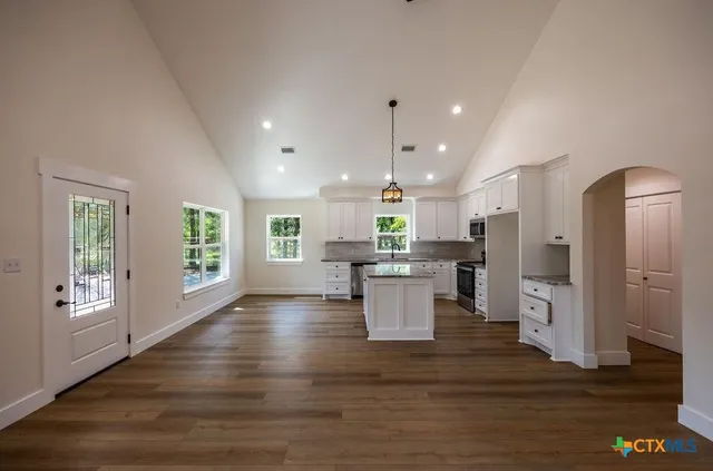 a open kitchen with white cabinets and stainless steel appliances