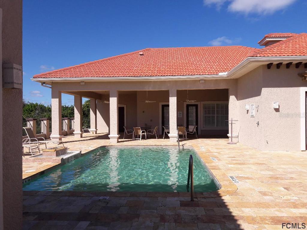 47 Shelter Cove Circle Beverly Beach, FL 32136 - Photo 12 of 21 a view of a house with backyard porch and sitting area