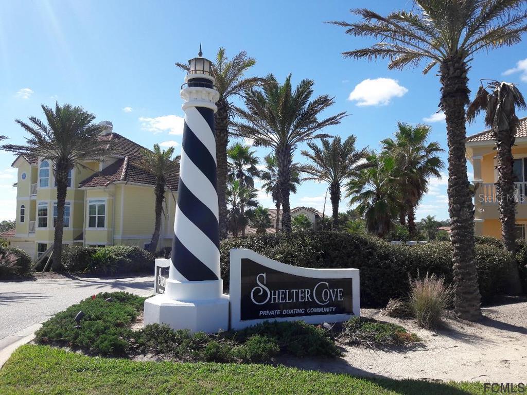 47 Shelter Cove Circle Beverly Beach, FL 32136 - Photo 2 of 21 a front view of a house with garden space and palm tree