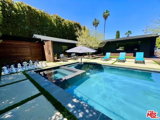 a view of a swimming pool with a patio