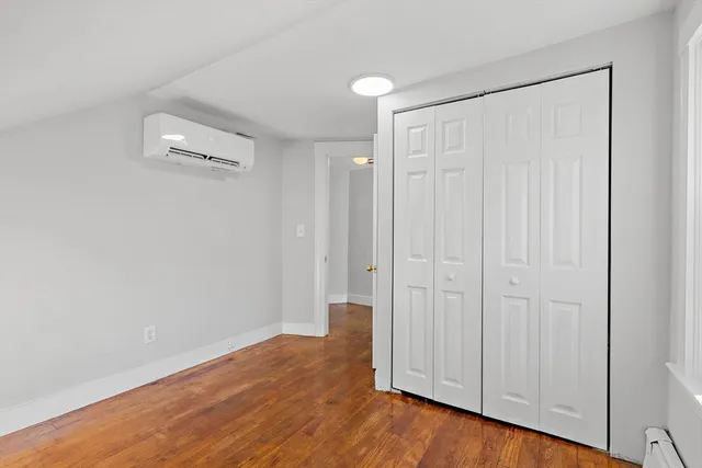 a view of a room with wooden floor
