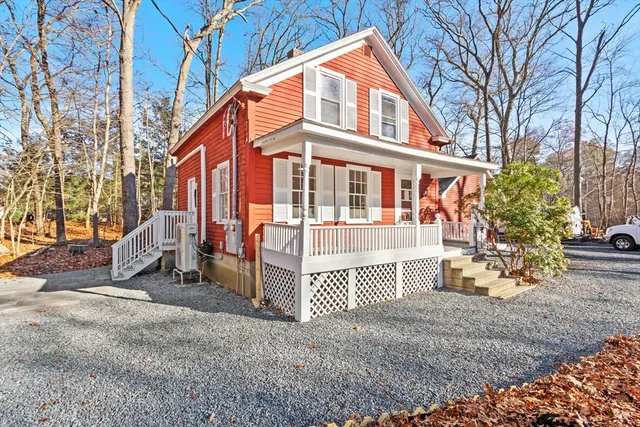 a view of a house with a yard and wooden fence