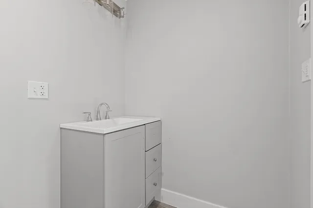 a bathroom with a sink and mirror