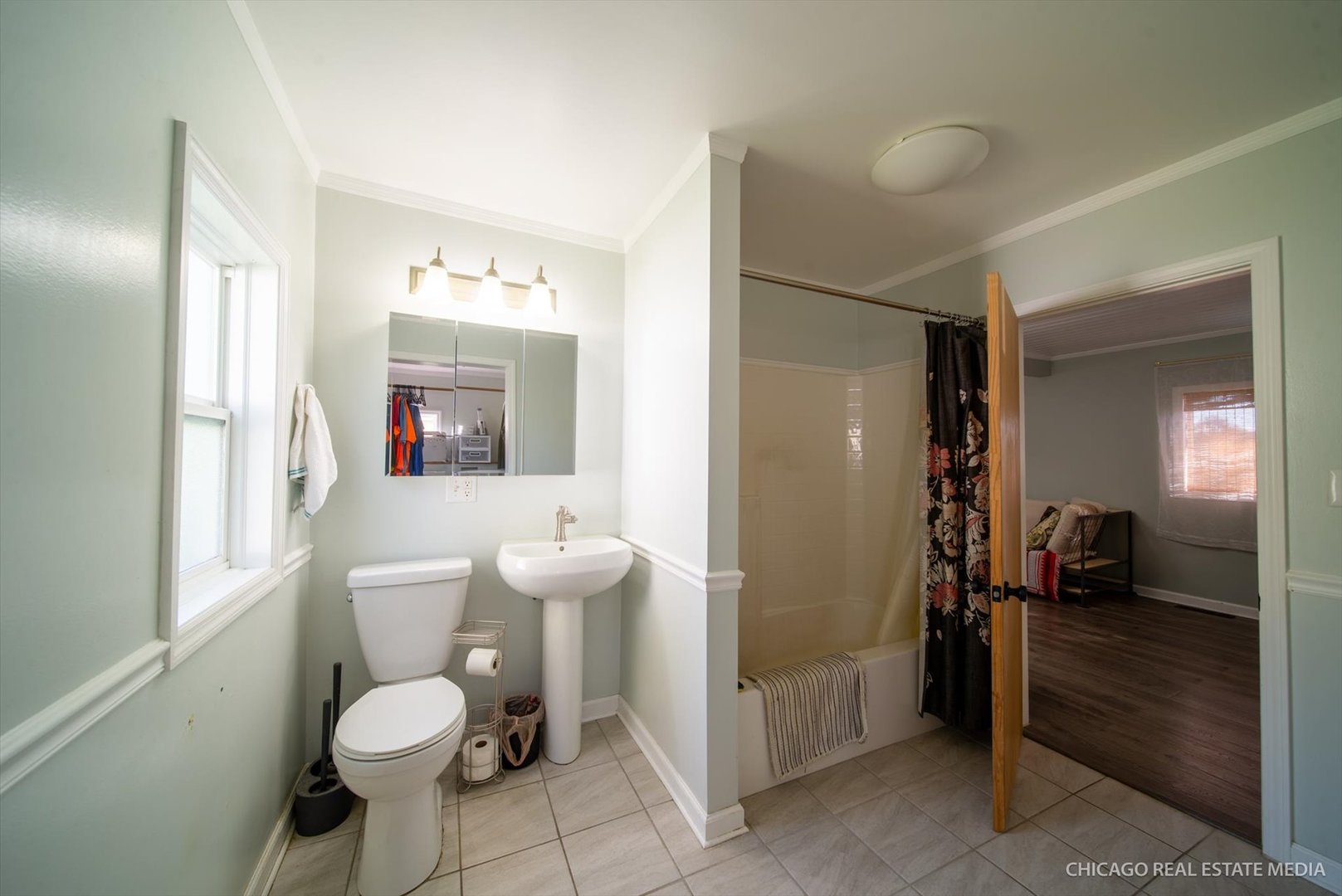 945 South 7th Street DeKalb, IL 60115 - Photo 15 of 18 a bathroom with a toilet sink a mirror and a shower