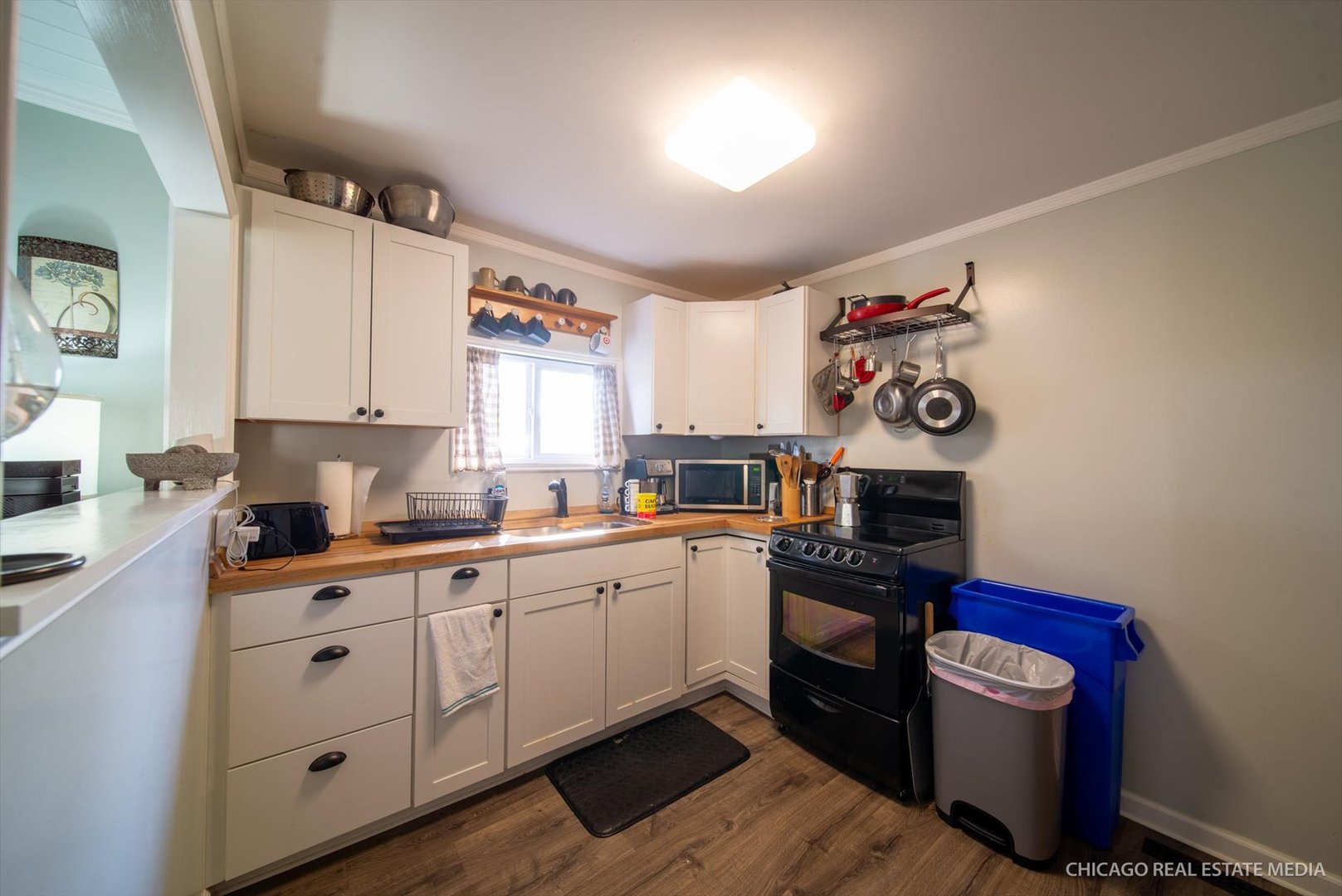 945 South 7th Street DeKalb, IL 60115 - Photo 10 of 18 a kitchen with granite countertop a white stove top oven sink and cabinets