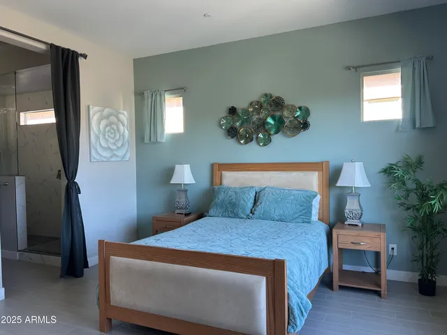 a bedroom with a bed and a potted plant