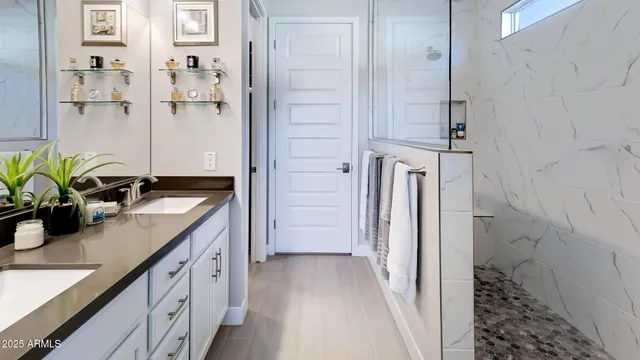 a bathroom with a granite countertop sink a mirror and a shower