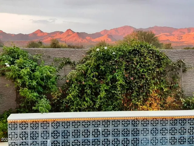 a view of a lake with a yard and large trees