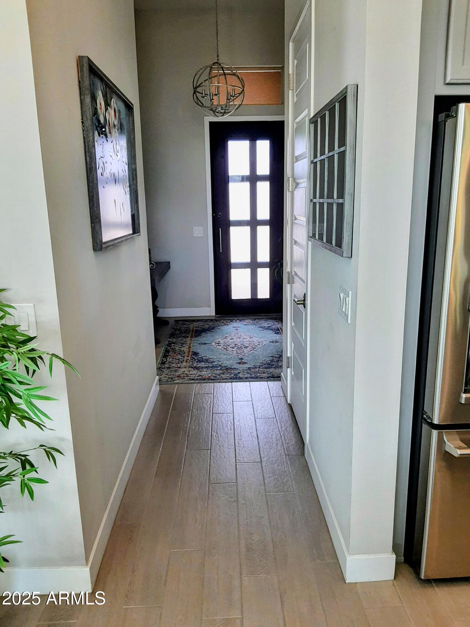 18828 East Blue Sky Drive Rio Verde, AZ 85263 - Photo 3 of 21 a view of a hallway with wooden floor and staircase