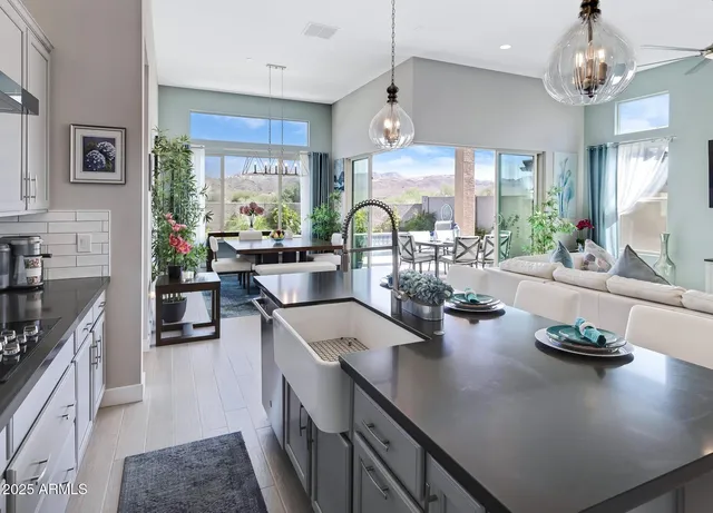 a kitchen with sink cabinets and chandelier