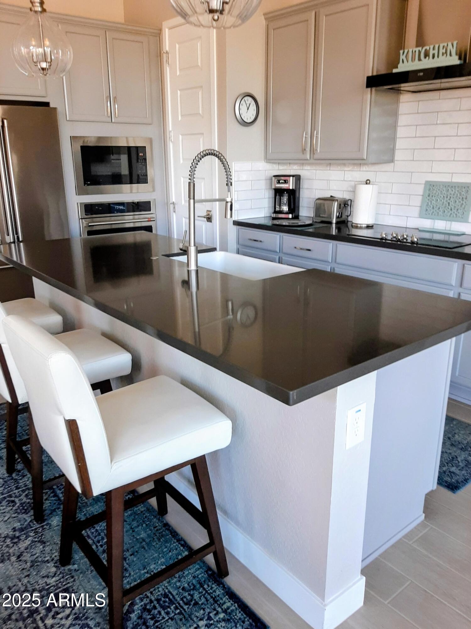 18828 East Blue Sky Drive Rio Verde, AZ 85263 - Photo 5 of 21 a kitchen with stainless steel appliances a stove a sink a microwave and cabinets