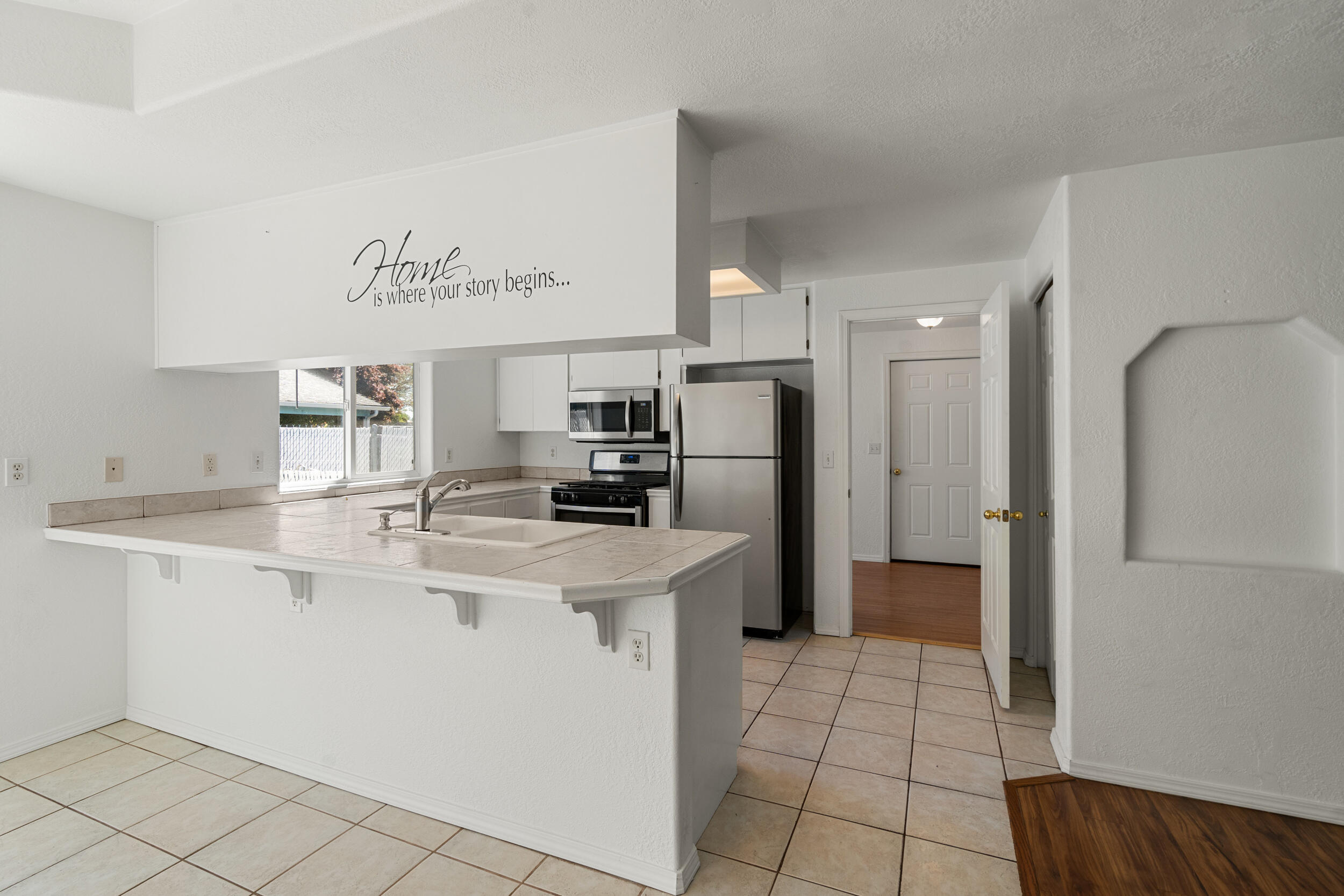 943 Hopkins Road Central Point, OR 97502 - Photo 8 of 21 a kitchen with a sink a refrigerator and cabinets