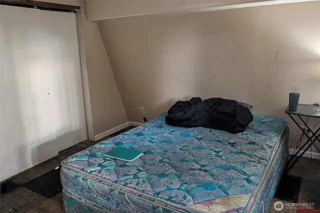 a bed sitting in a bedroom next to a window