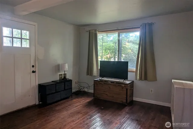 a living room with furniture and flat screen tv