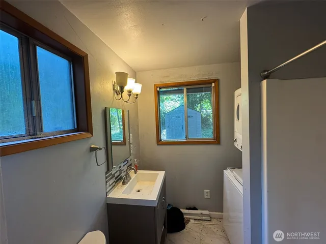 a bathroom with a sink a toilet and mirror