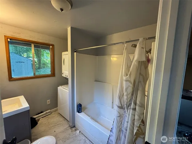 a bathroom with a bathtub and shower