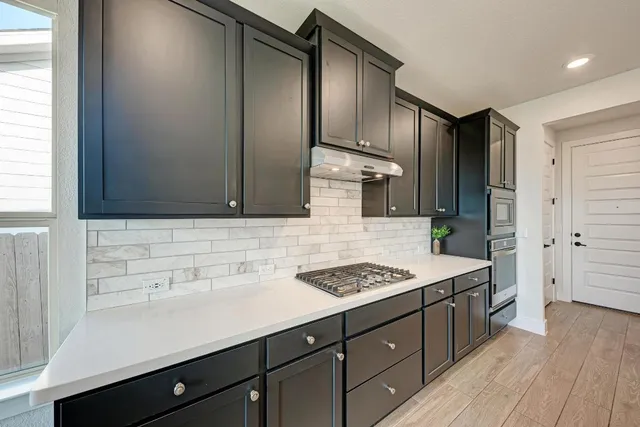 a view of a kitchen with a sink and a refrigerator