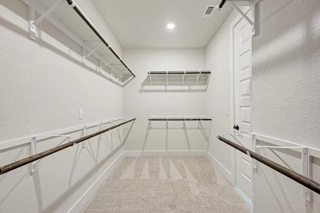 a spacious bathroom with a shower sink and mirror