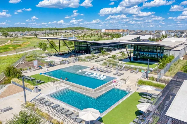 a view of a swimming pool with outdoor seating