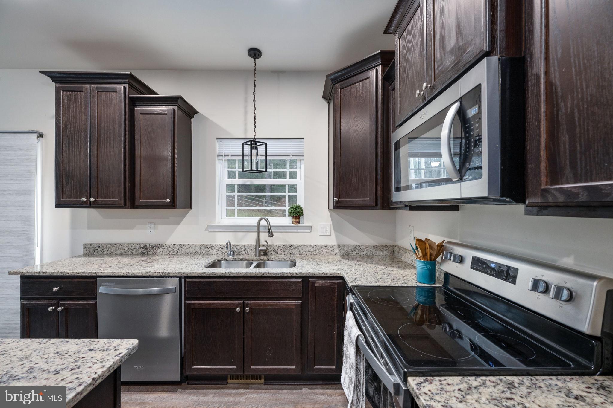 794 White Oak Road Fredericksburg, VA 22405 - Photo 22 of 70 a kitchen with a sink stove and cabinets