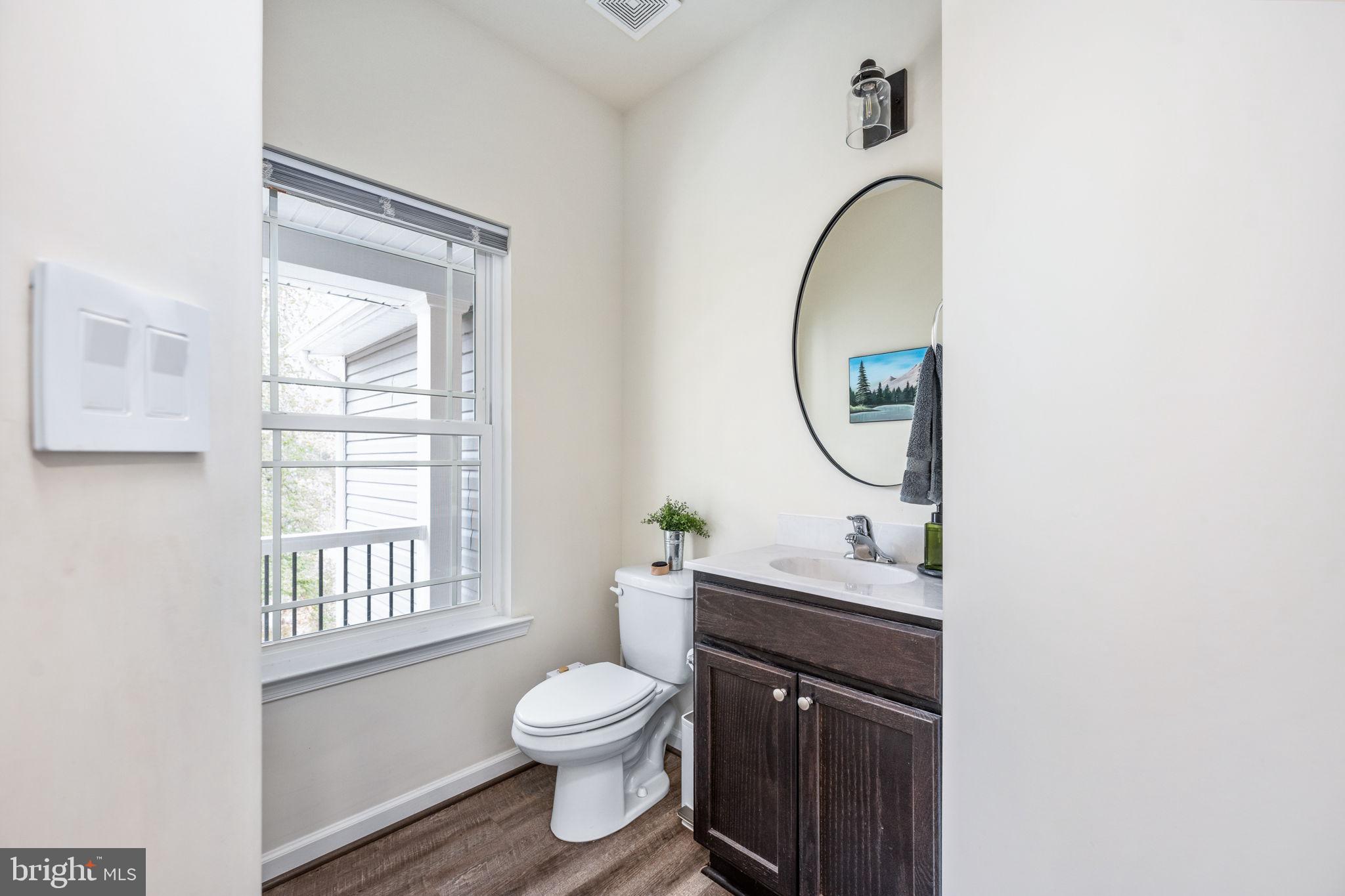 794 White Oak Road Fredericksburg, VA 22405 - Photo 29 of 70 a bathroom with a toilet a sink and a mirror