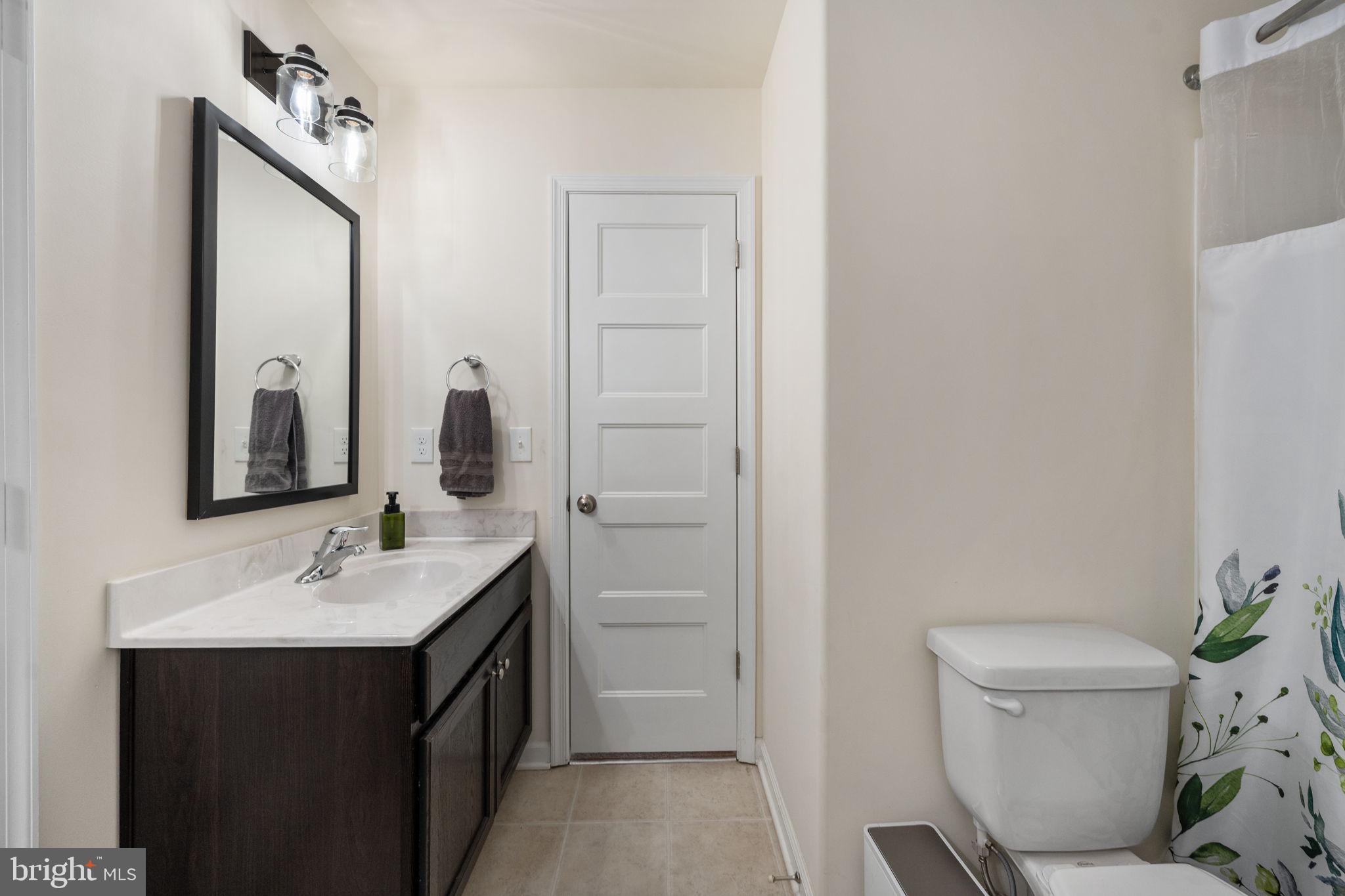 794 White Oak Road Fredericksburg, VA 22405 - Photo 37 of 70 a bathroom with a sink a toilet and a mirror