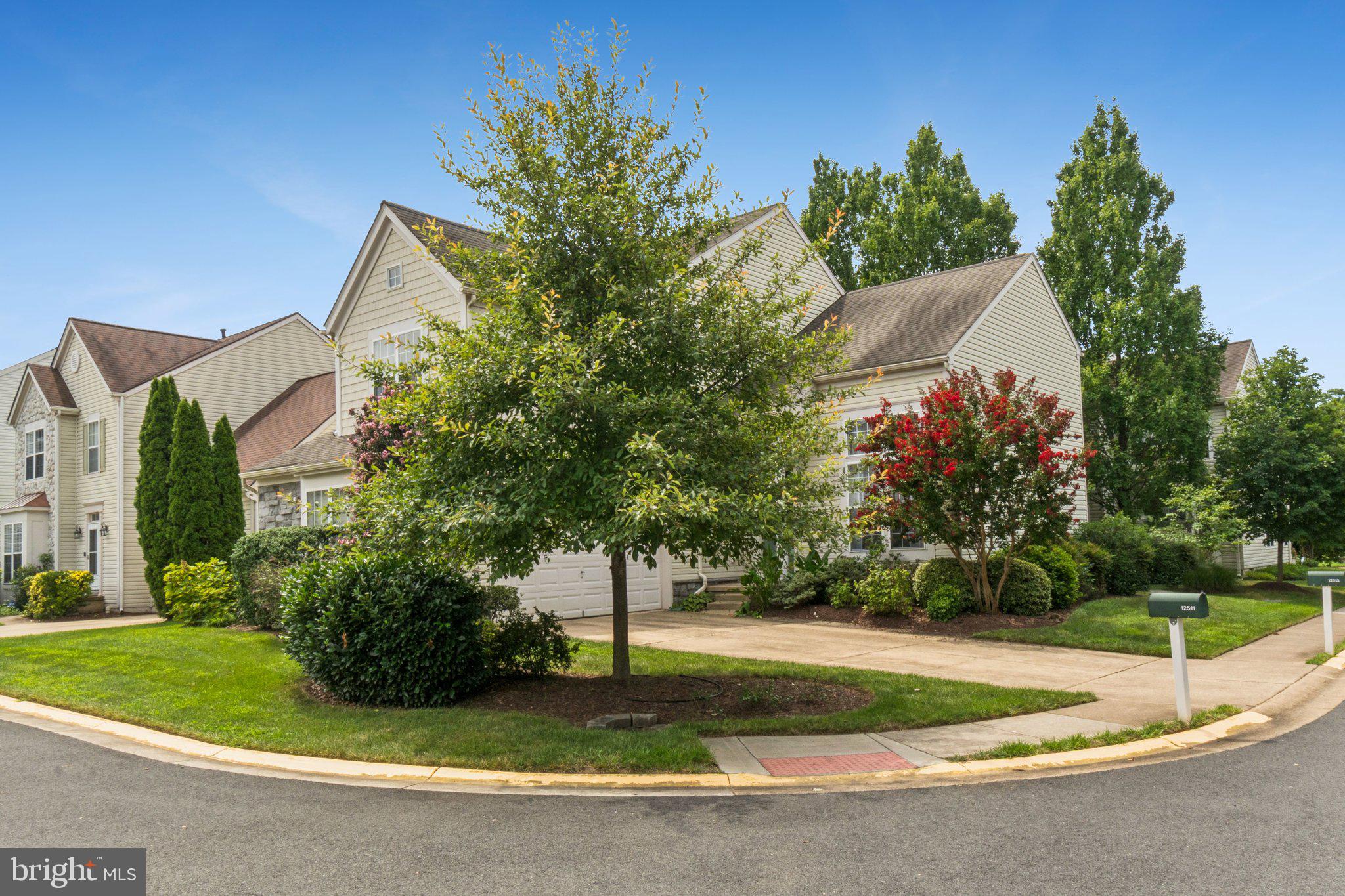 12513 Fox View Way Reston, VA 20191 - Photo 1 of 39 a front view of a house with a yard and garage