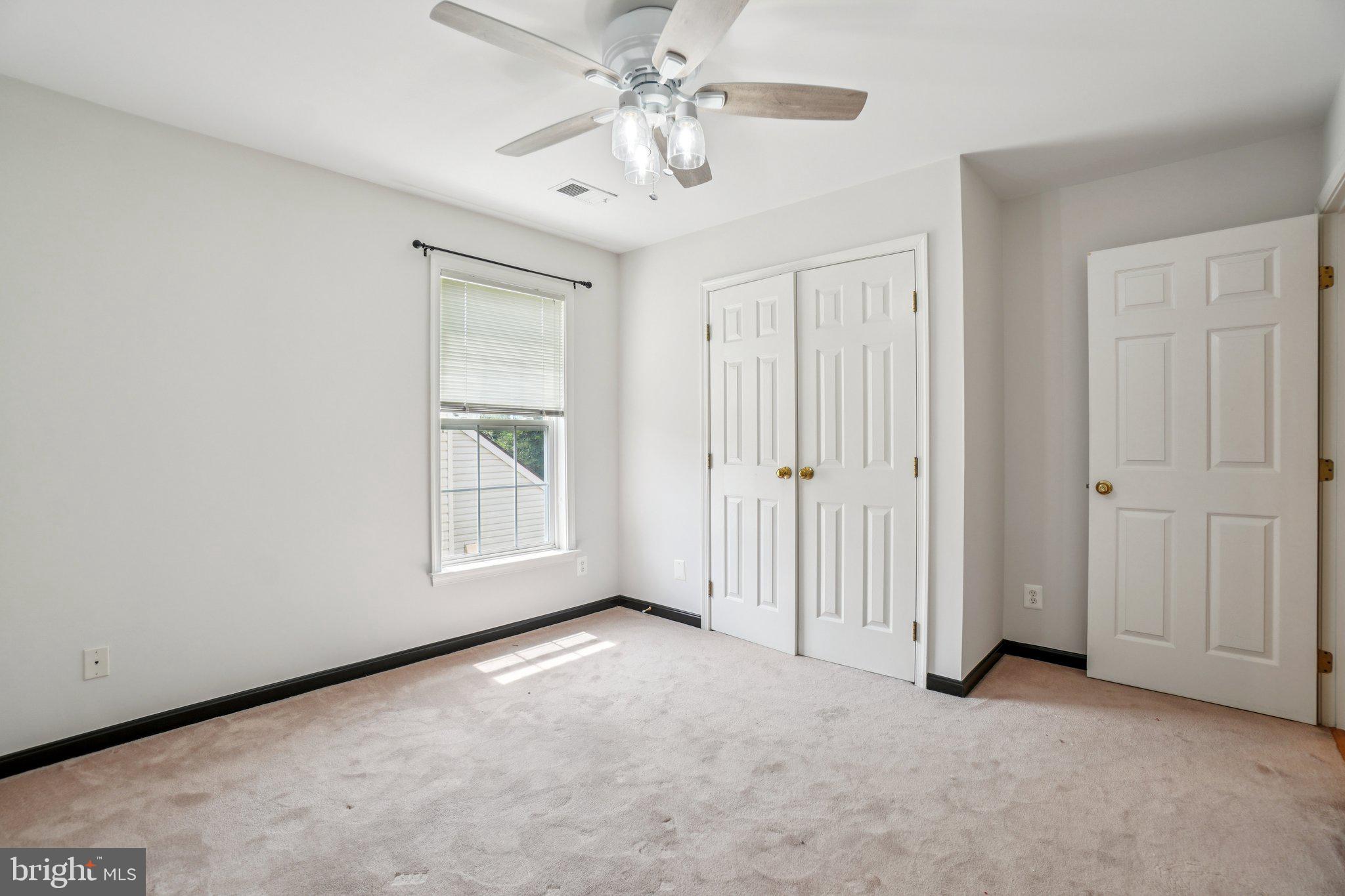 12513 Fox View Way Reston, VA 20191 - Photo 14 of 39 an empty room with chandelier fan and windows