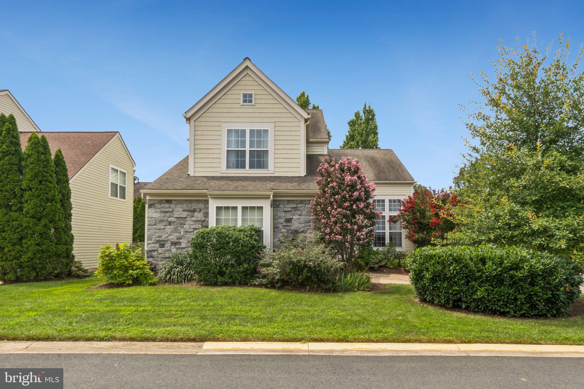 12513 Fox View Way Reston, VA 20191 - Photo 35 of 39 a front view of a house with a garden