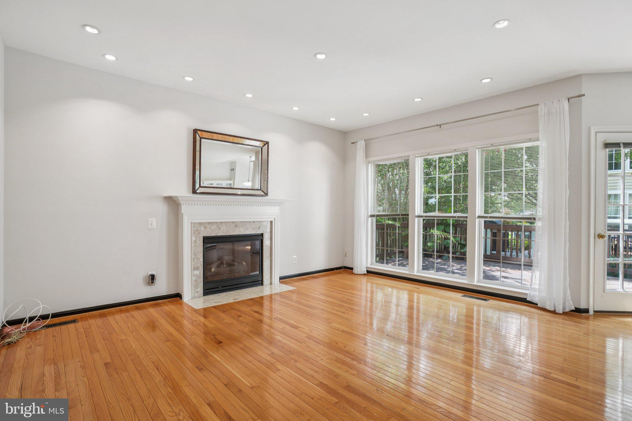 12513 Fox View Way Reston, VA 20191 - Photo 9 of 39 a view of an empty room with a fireplace and a window