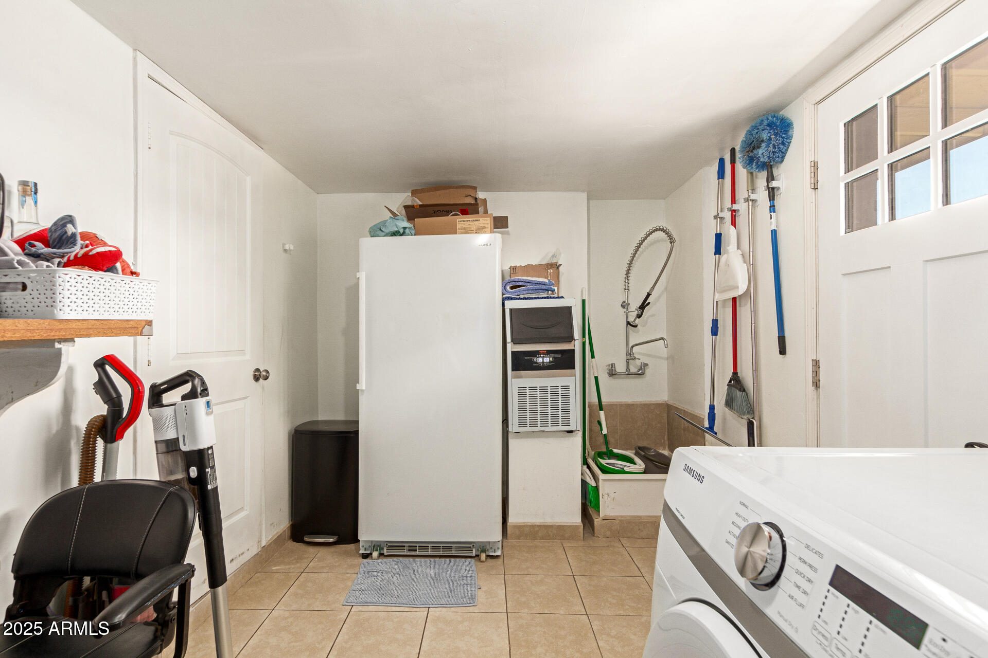 1221 East Alta Vista Road Phoenix, AZ 85042 - Photo 12 of 33 a room with a refrigerator and a couch