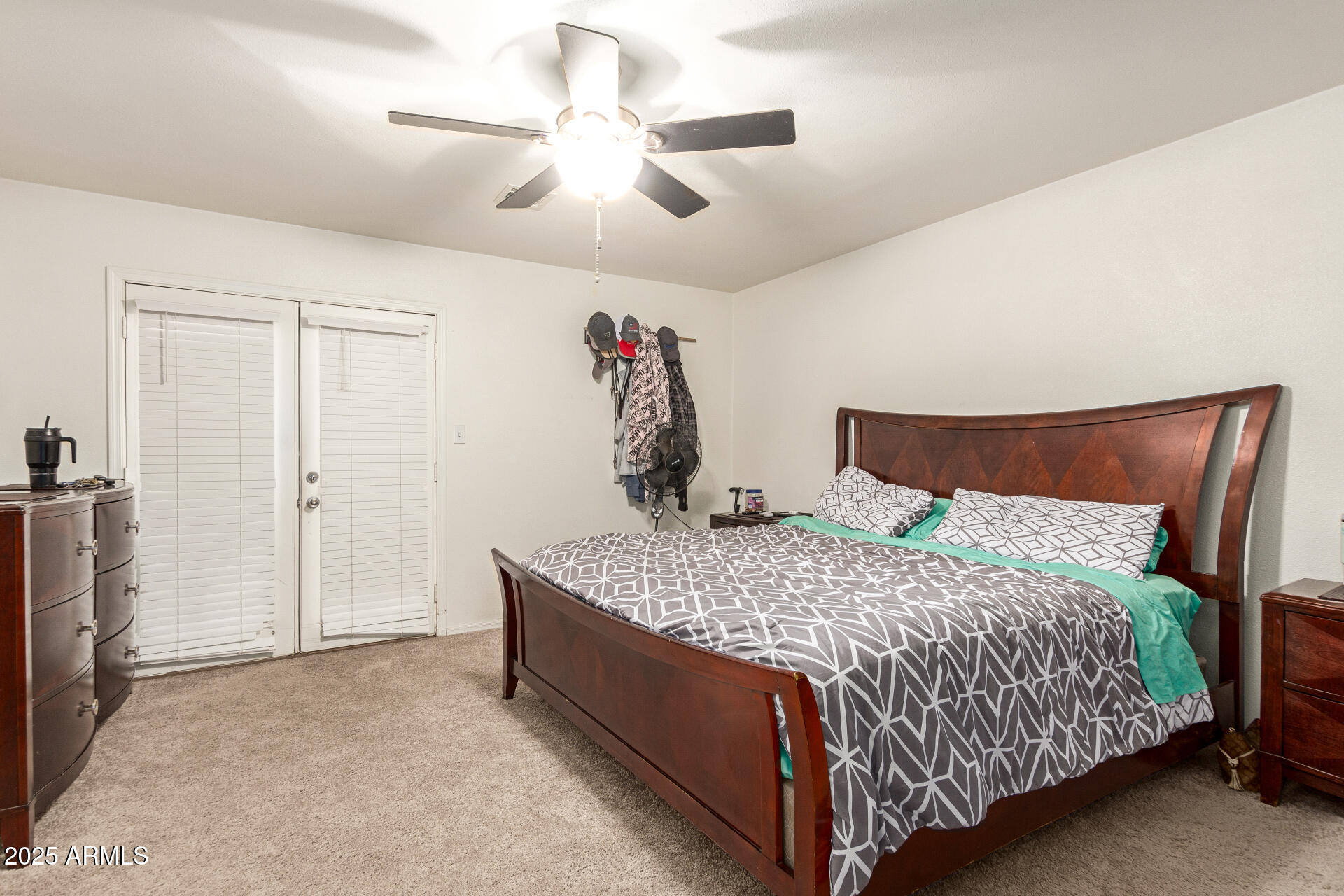 1221 East Alta Vista Road Phoenix, AZ 85042 - Photo 13 of 33 a bedroom with a bed and a chandelier