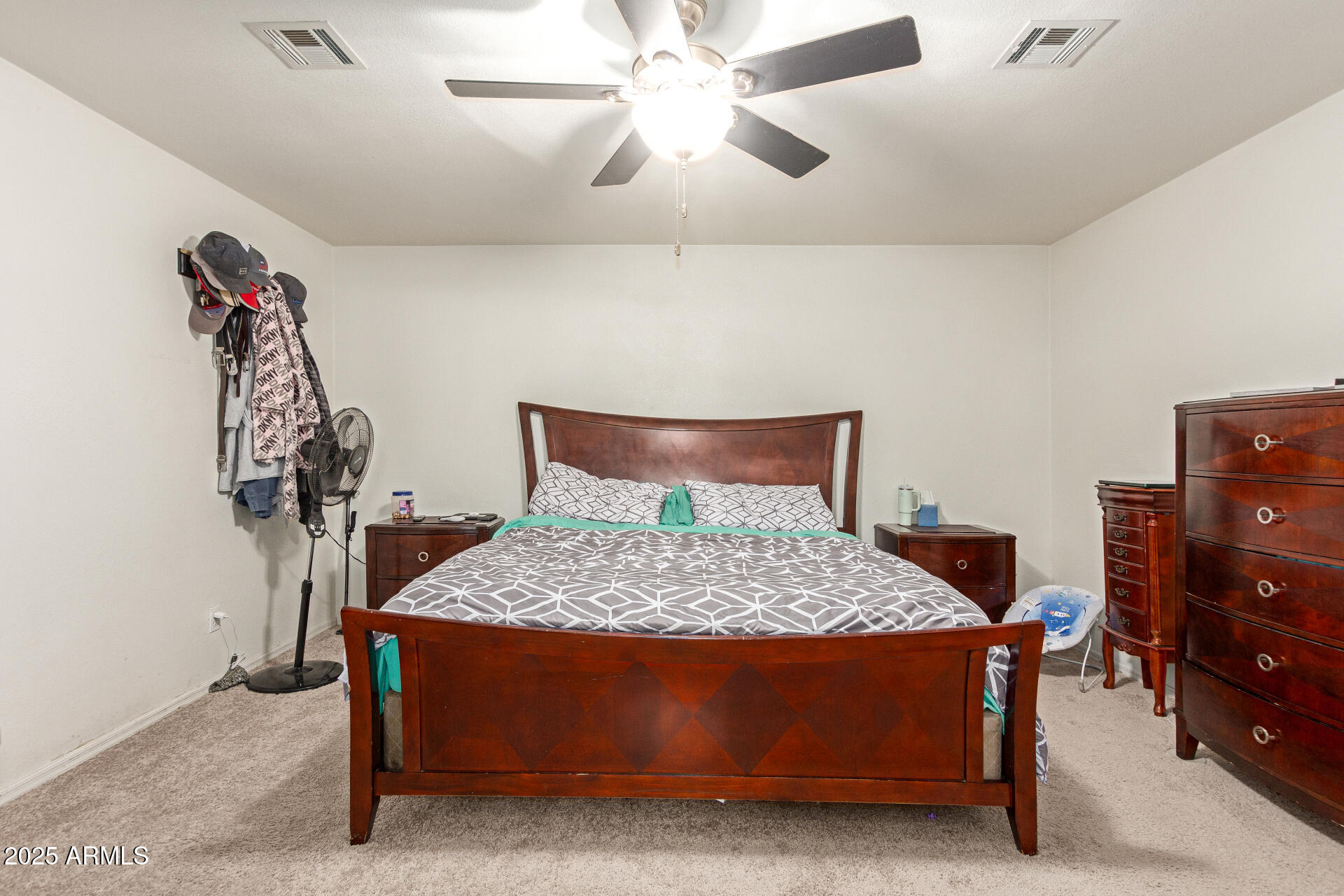 1221 East Alta Vista Road Phoenix, AZ 85042 - Photo 14 of 33 a bedroom with a bed and a chandelier