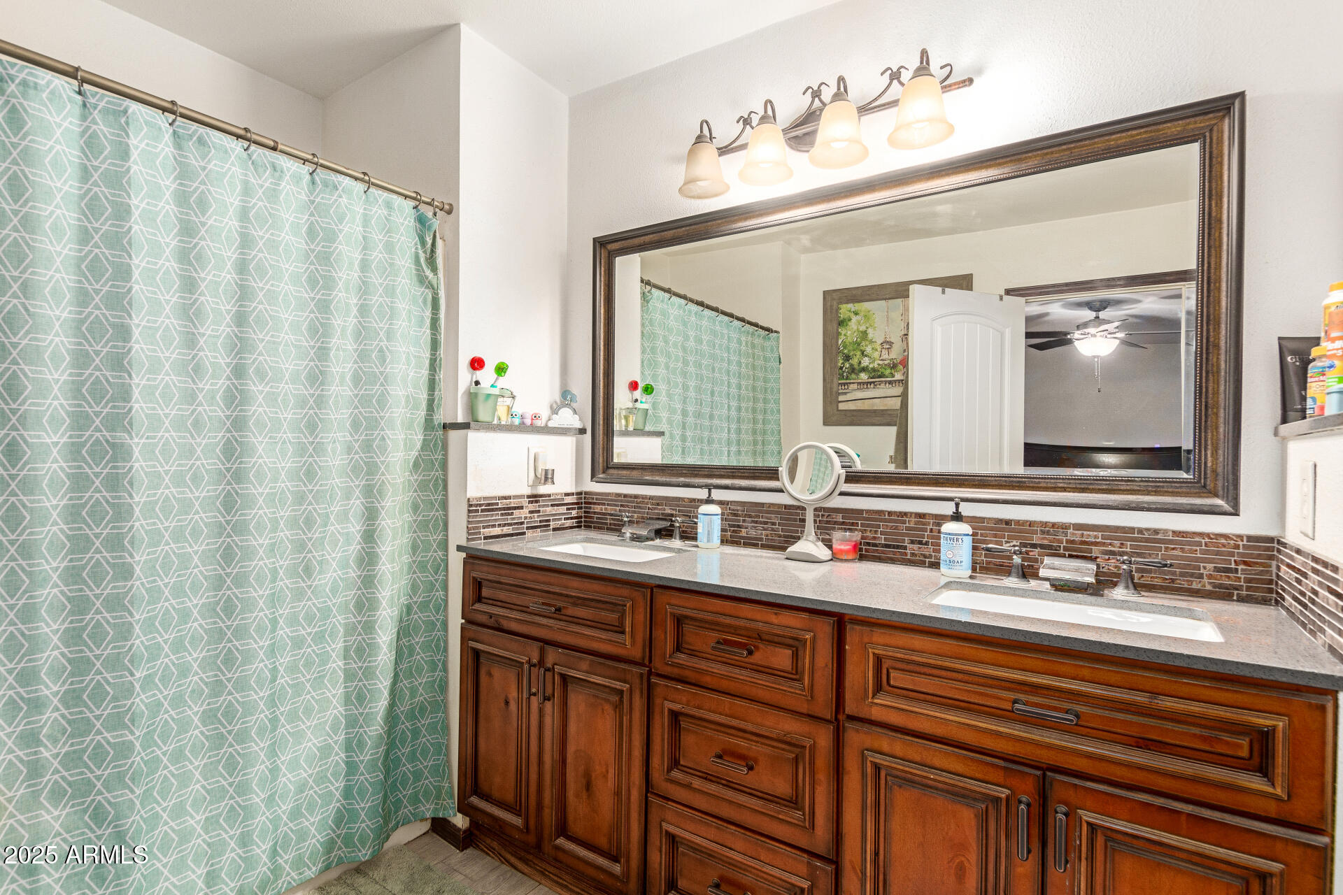 1221 East Alta Vista Road Phoenix, AZ 85042 - Photo 15 of 33 a bathroom with a double vanity sink and mirror