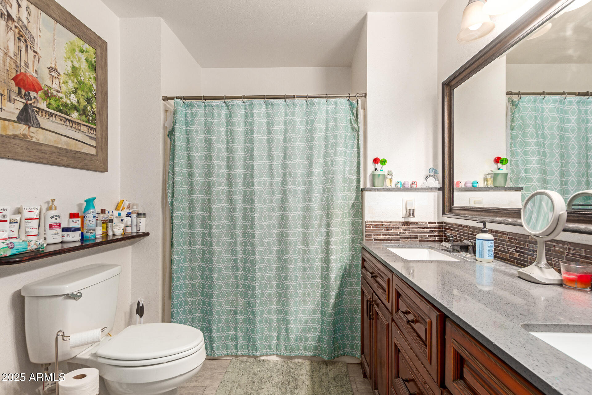 1221 East Alta Vista Road Phoenix, AZ 85042 - Photo 16 of 33 a bathroom with a granite countertop toilet sink and mirror