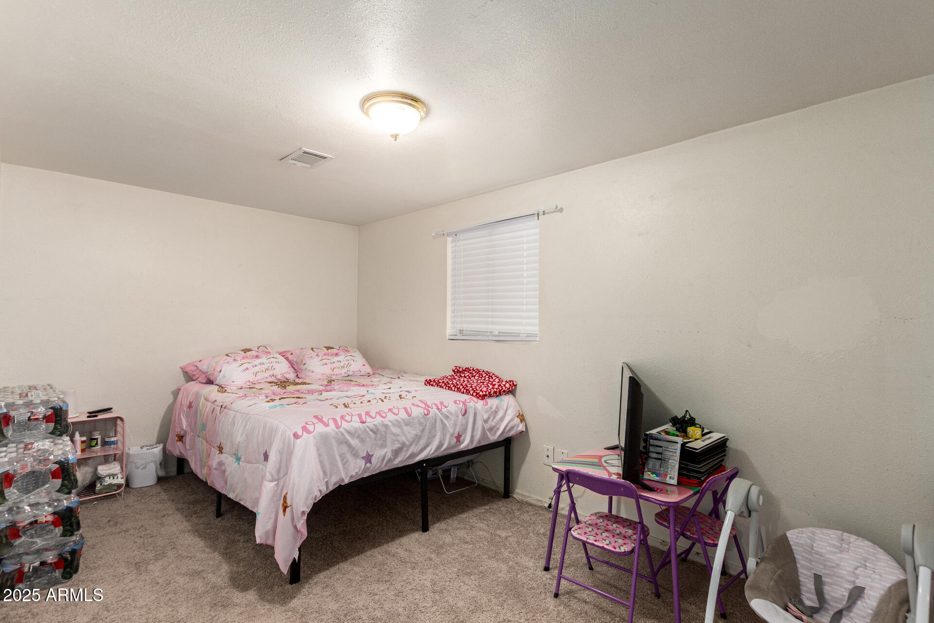 1221 East Alta Vista Road Phoenix, AZ 85042 - Photo 17 of 33 a bed room with a bed and a chair