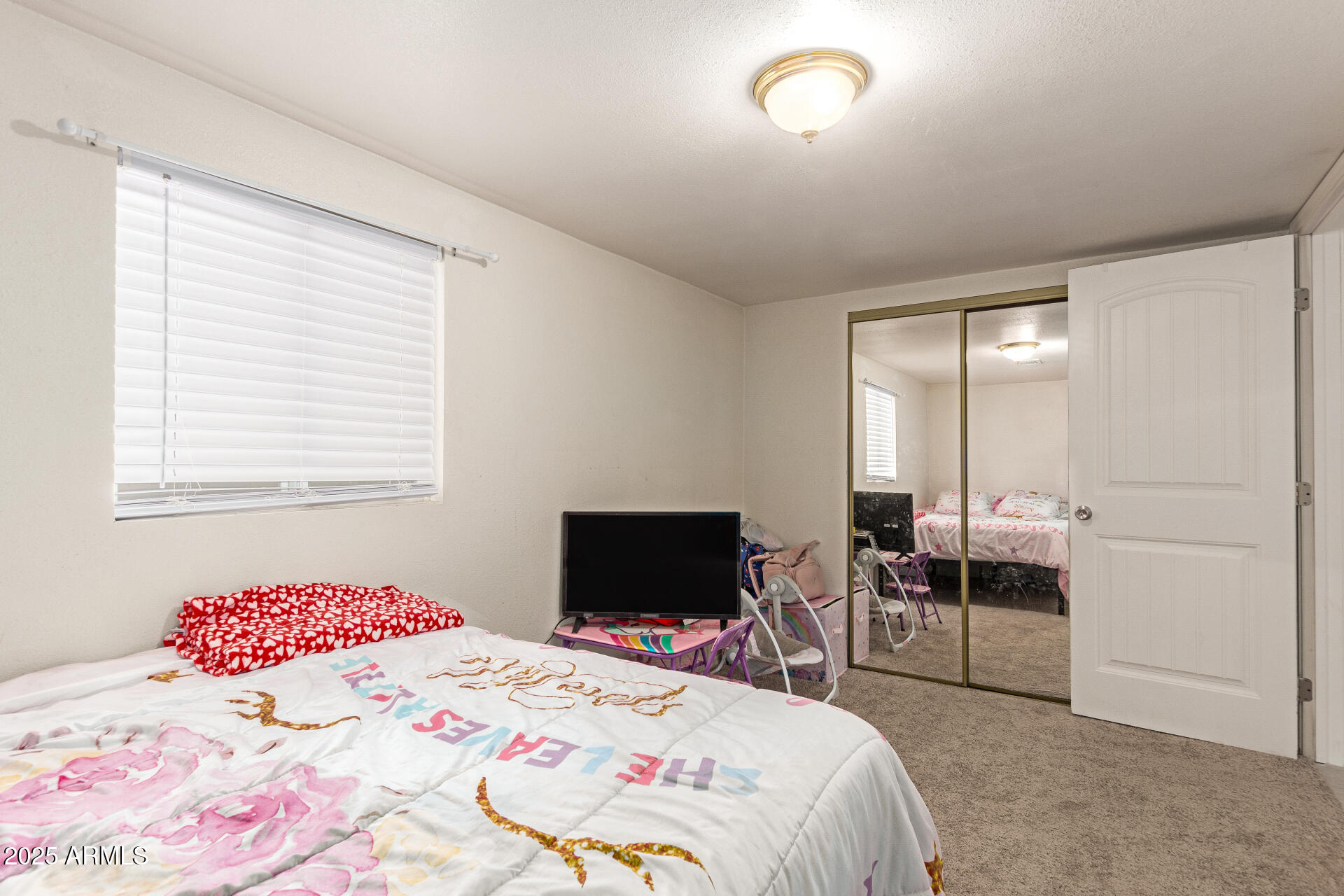1221 East Alta Vista Road Phoenix, AZ 85042 - Photo 18 of 33 a bedroom with a bed and a table