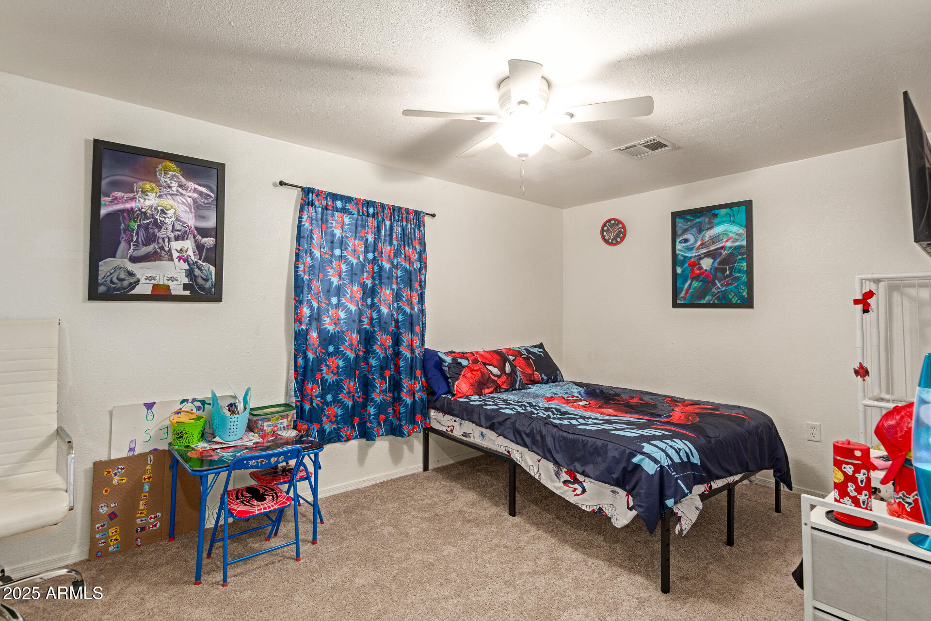 1221 East Alta Vista Road Phoenix, AZ 85042 - Photo 19 of 33 a bedroom with a bed and a chandelier