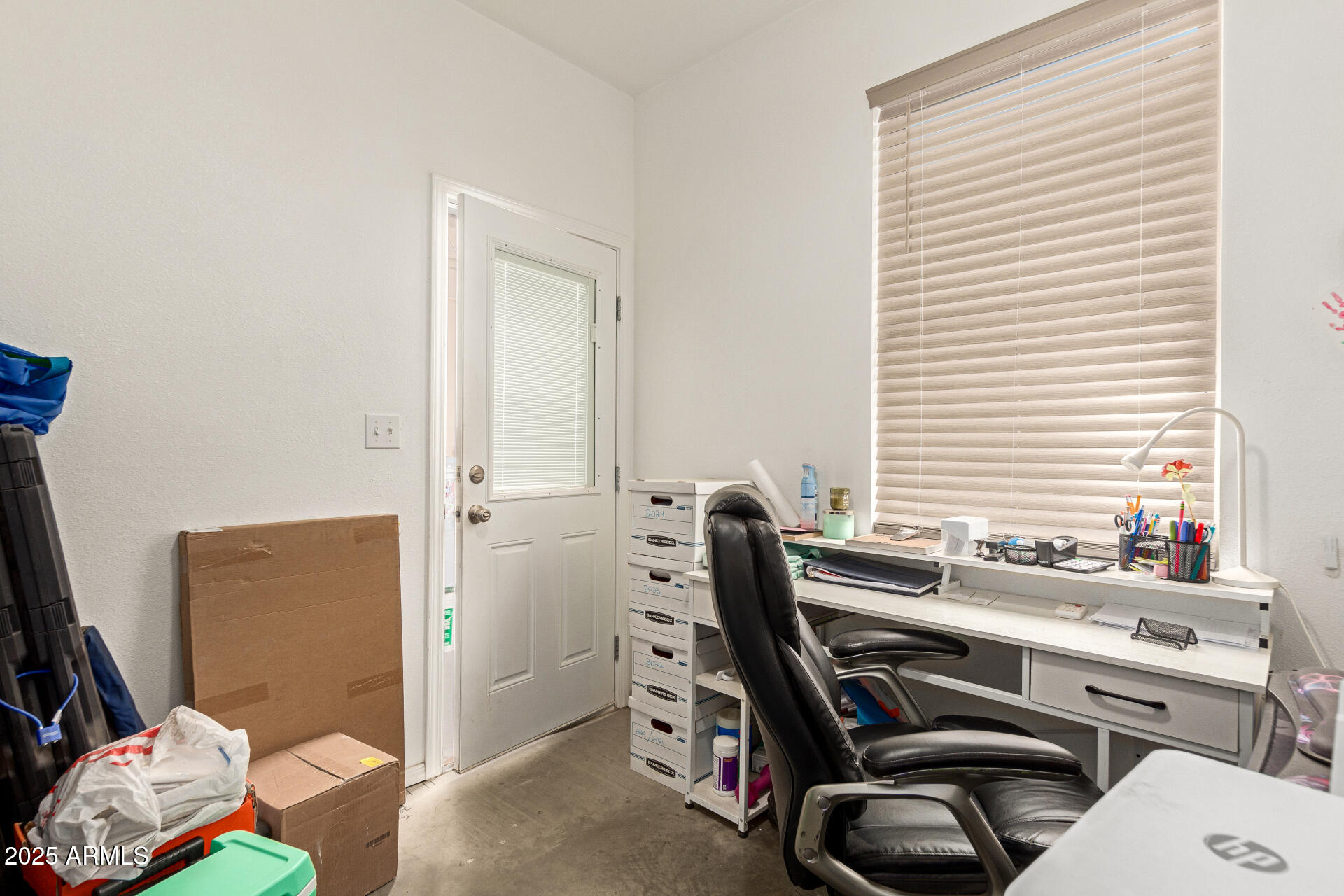 1221 East Alta Vista Road Phoenix, AZ 85042 - Photo 24 of 33 a view of a workspace with furniture and a window