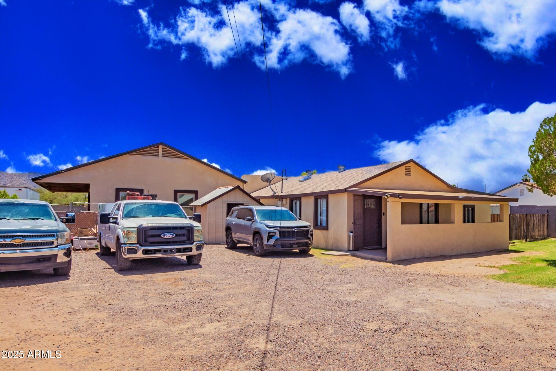 1221 East Alta Vista Road Phoenix, AZ 85042 - Photo 2 of 33 a car parked in front of a house