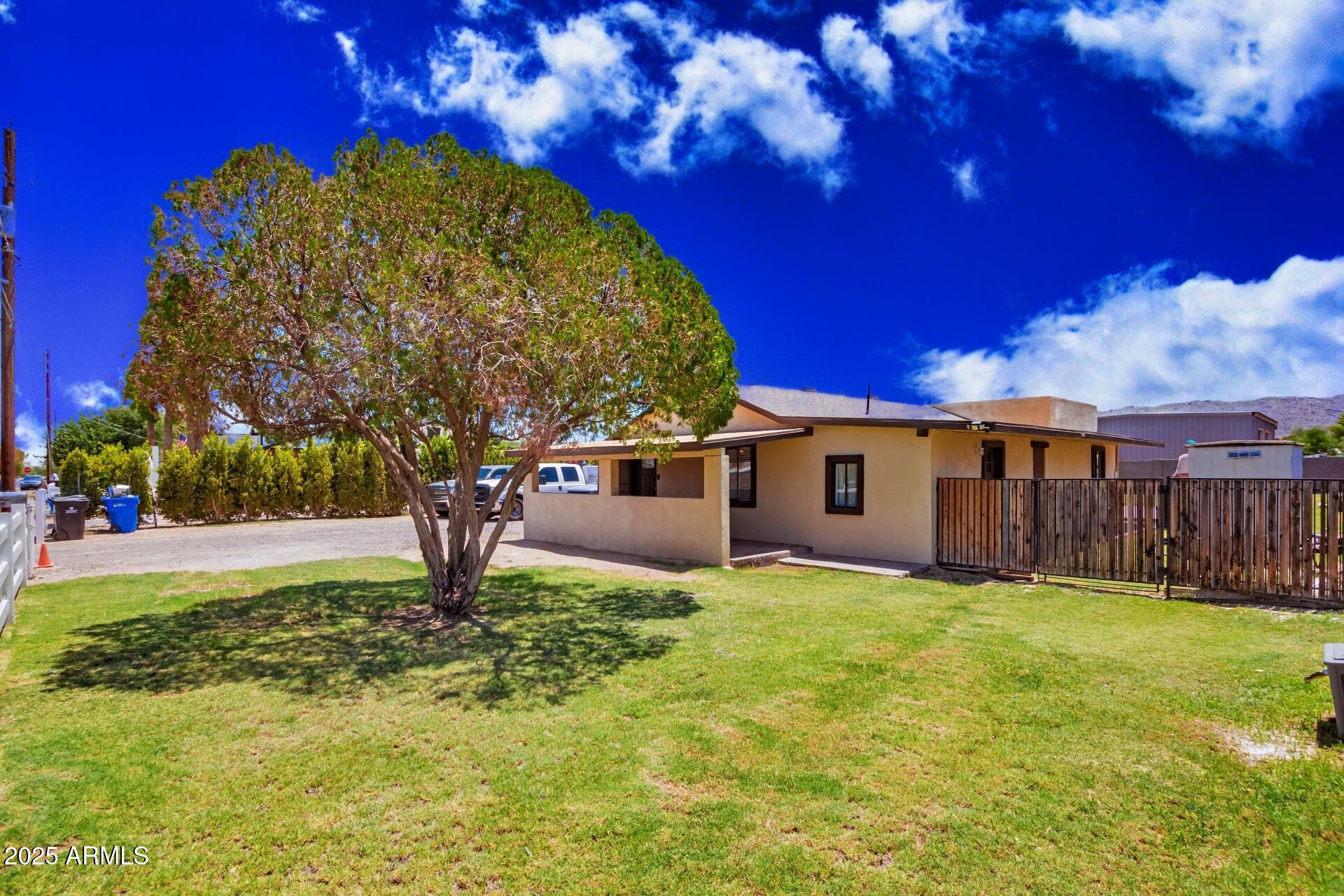 1221 East Alta Vista Road Phoenix, AZ 85042 - Photo 3 of 33 a view of a house with a yard