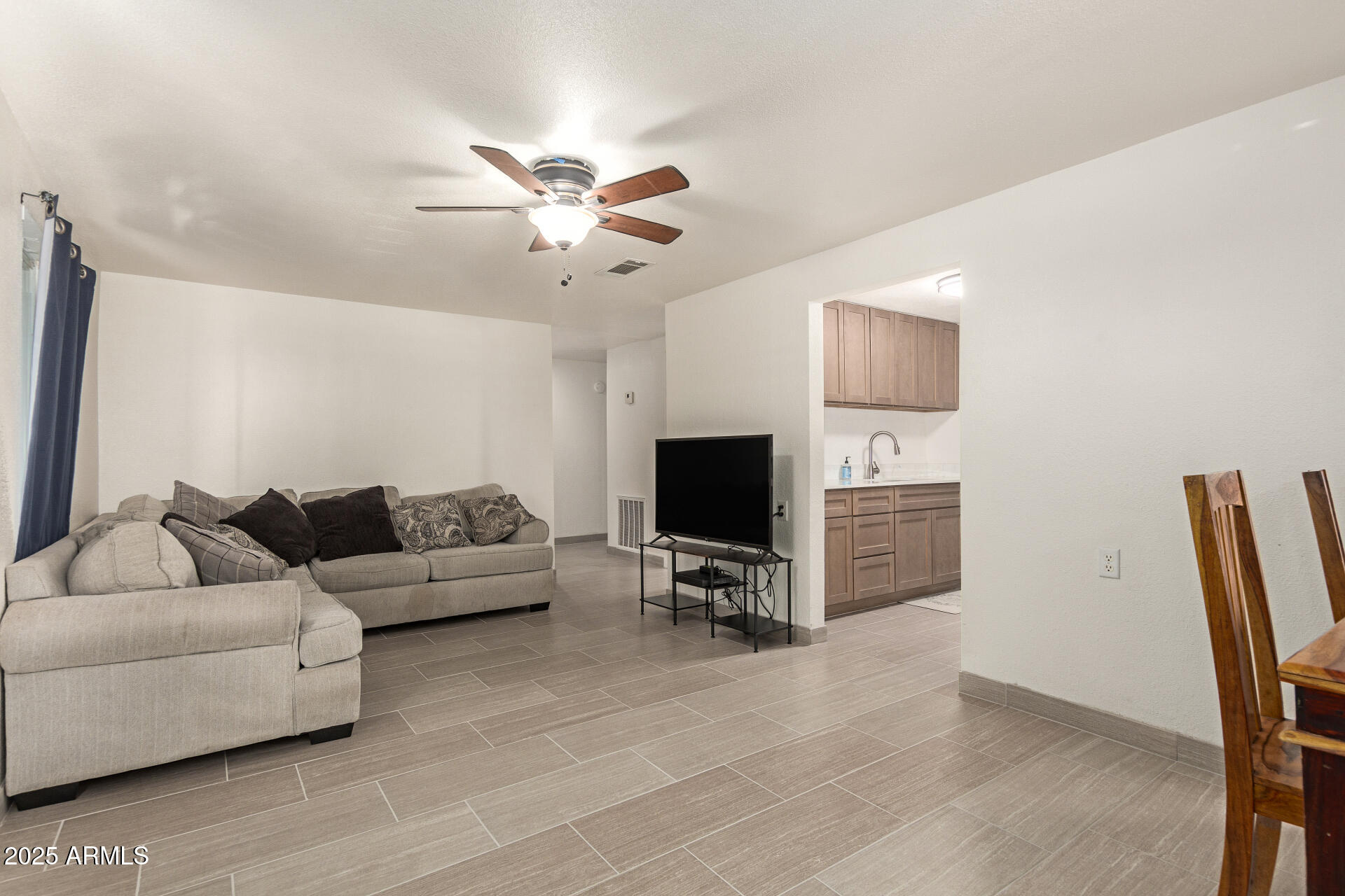 1221 East Alta Vista Road Phoenix, AZ 85042 - Photo 6 of 33 a living room with furniture and a flat screen tv